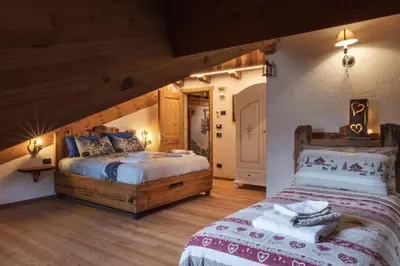 a bedroom with two beds in a room at ALLE ANTICHE MINIERE - CASA VACANZE in Zenich