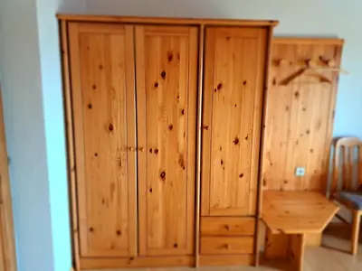 a wooden cabinet in a room with a wooden table at Webergütl in Auna di Sopra