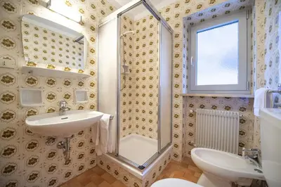 a bathroom with a sink and a shower at Alara Rooms in Ortisei