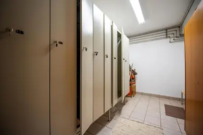 a hallway with white closets and a tile floor at Zilli Rooms in Laion