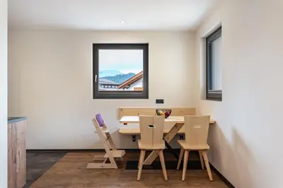 a dining room with a table and chairs at Villa Lara Föhre in Kastelruth