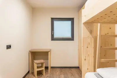 a bedroom with a bunk bed and a window at Villa Lara Föhre in Kastelruth