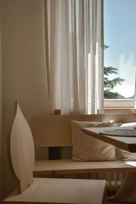 a living room with a window and a table at Alpimena Natur-Apartments Meran in Merano