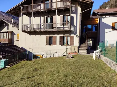 a house with a yard in front of it at Casa Sartorin in Canale San Bovo