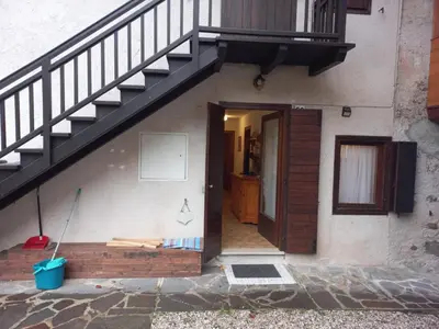 a stairway leading to a house with a door and a staircase at Casa Sartorin in Canale San Bovo