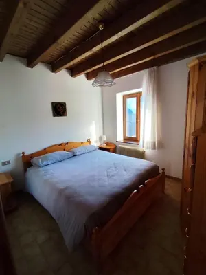 a bedroom with a large bed in a room at Casa Relax in Canale San Bovo