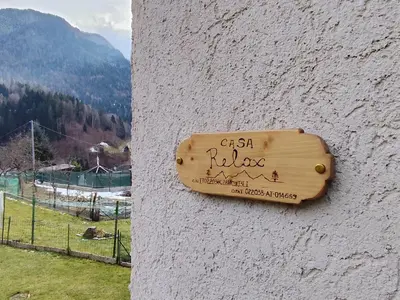 a sign on the side of a wall at Casa Relax in Canale San Bovo