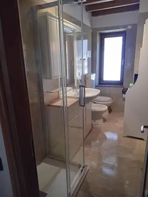 a bathroom with a glass shower and two toilets at Casa Relax in Canale San Bovo