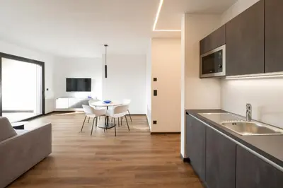 a kitchen and dining room with a table and chairs at Moerlhof in Caldaro