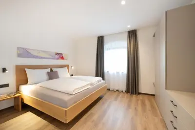a bedroom with a white bed and a window at Moerlhof in Caldaro