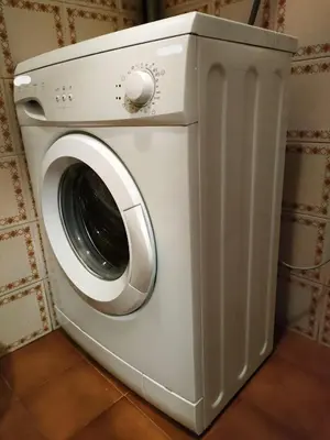 a white washing machine in a room at Casa Righini in Moena