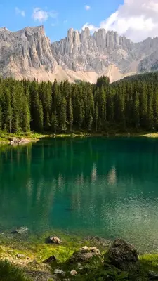 a large blue lake with mountains in the background at Casa Righini in Moena