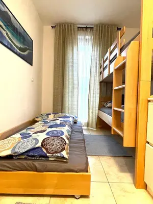 a small bedroom with a bed and bunk beds at T&B MOUNTAIN VIEW in Monguelfo