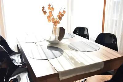 a wooden table with a vase of flowers on it at T&B MOUNTAIN VIEW in Monguelfo