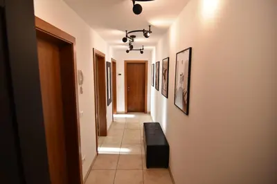a hallway with a black bench in a room at T&B MOUNTAIN VIEW in Monguelfo