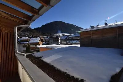 a snow covered balcony with a view of a mountain at T&B MOUNTAIN VIEW in Monguelfo