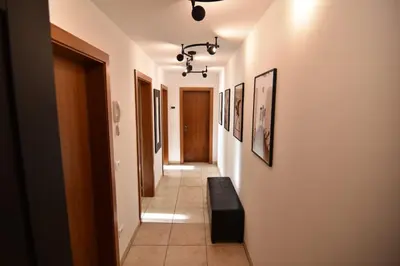 a hallway with a black bench in a room at T&B MOUNTAIN VIEW in Monguelfo