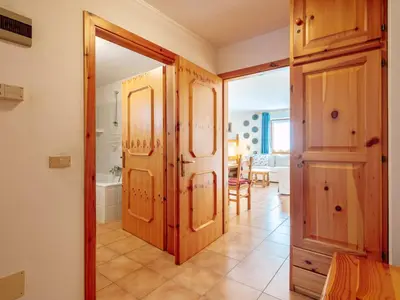 a hallway with a door open to a room with a bathroom at Apartment Mason Scarzin by Interhome in Alba di Canazei