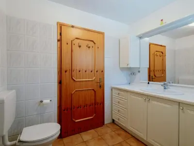 a room with two bunk beds and a table at Apartment Mason Scarzin by Interhome in Alba di Canazei