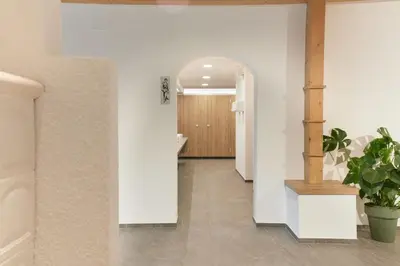 a hallway with white walls and a potted plant at Camping Marmolada Malga Ciapela - Glamping Experience in Malga Ciapela