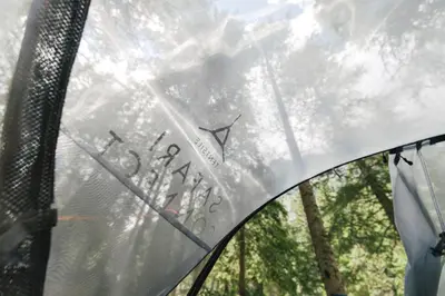 a glass window with writing on it with trees in the background at Camping Marmolada Malga Ciapela - Glamping Experience in Malga Ciapela