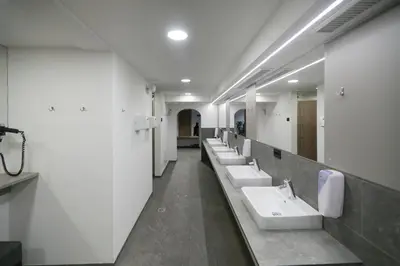 a bathroom with a row of sinks and mirrors at Camping Marmolada Malga Ciapela - Glamping Experience in Malga Ciapela