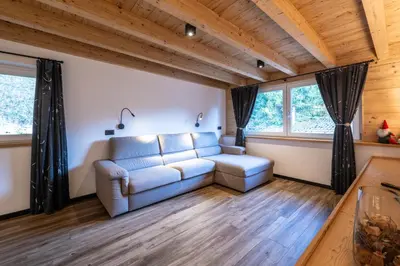 a living room with a couch and two windows at - Piz Boe - Canazei center app. in Canazei