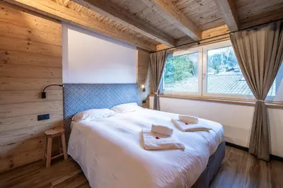 a bedroom with a bed and a large window at - Piz Boe - Canazei center app. in Canazei