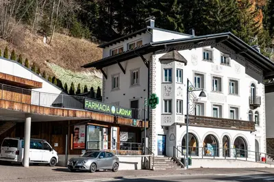 a white building with a car parked in front of it at - Piz Boe - Canazei center app. in Canazei
