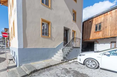 a white car parked in front of a building at Casa Caviola Centro in Falcade