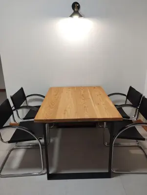 a wooden table with four black chairs around it at Loft 69 - Green Relax in Cles