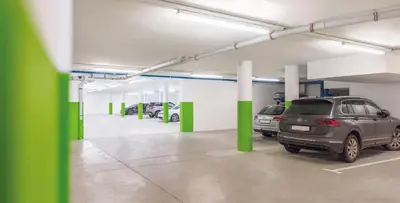 a parking garage with two cars parked in it at Hotel DAS ROYAL in Obereggen in Obereggen