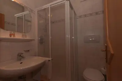 a bathroom with a shower and a toilet and a sink at Haus Sabine in Laion
