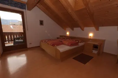 a large bedroom with a bed and a large window at Haus Sabine in Laion