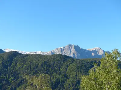 a mountain in the distance with trees in the foreground at Haus Sabine in Laion