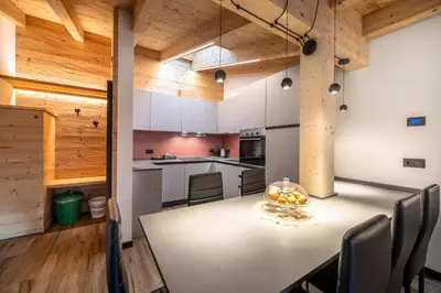 a large kitchen with a table and chairs at - Punta Penia - Canazei center app in Canazei