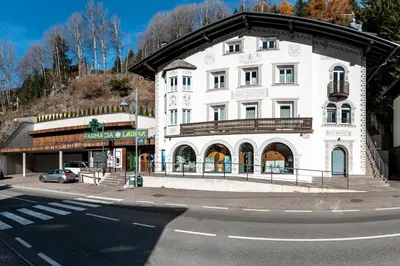 a large white building on the corner of a street at - Punta Penia - Canazei center app in Canazei