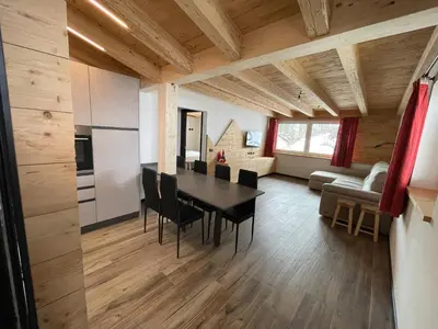 a kitchen and dining room with a table and chairs at - Punta Penia - Canazei center app in Canazei
