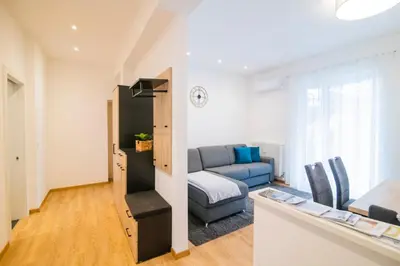 a living room with a couch and a table at Stay City in MeranO with Bio Sauna in Merano
