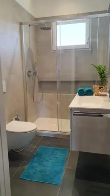 a bathroom with a shower and a toilet and a sink at Stay City in MeranO with Bio Sauna in Merano