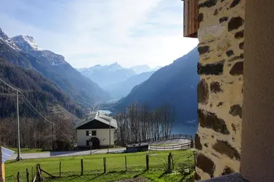 a view of a valley with mountains and a building at Civetta panoramic mountain home in Alleghe