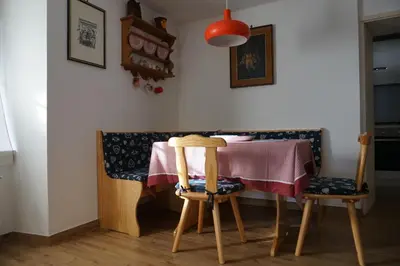 a dining room with a table and two chairs at Civetta panoramic mountain home in Alleghe
