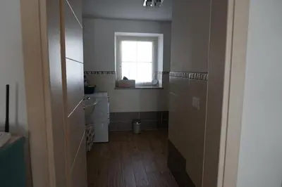 a bathroom with a window and a sink and a toilet at Civetta panoramic mountain home in Alleghe