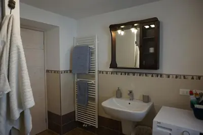 a bathroom with a sink and a mirror at Civetta panoramic mountain home in Alleghe
