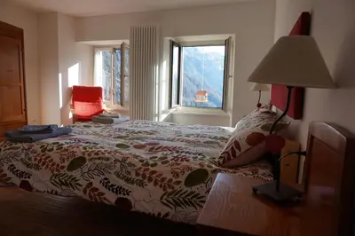 a bedroom with a bed and a window at Civetta panoramic mountain home in Alleghe