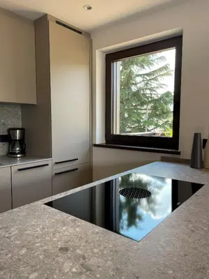 a kitchen with a reflection of a window on a counter at Apartment Malfi in Fiè
