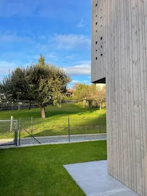 a tall building with a park in the background at Apartment Malfi in Fiè