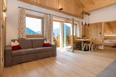 a living room with a couch and a dining room at Bäckerhof in Tesido