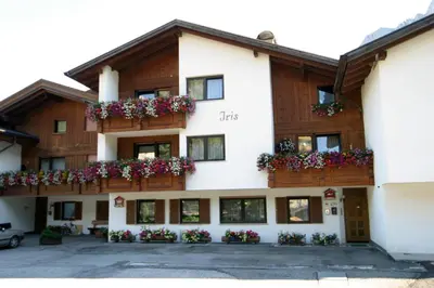 a building with flower boxes on the balconies at Ciasa Gabriel in Colfosco