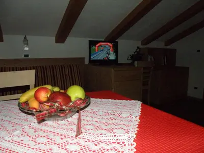 a bowl of fruit on a table with a red table cloth at Ciasa Gabriel in Colfosco